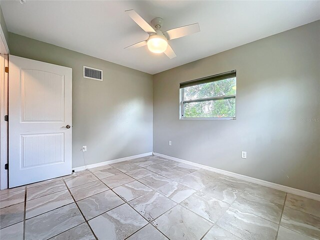 9506 Number Two Rd, Howey In The Hills, FL 34737 - empty room featuring baseboards, ceiling fan, and light marble finish floors