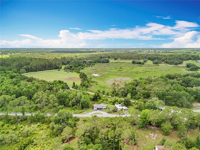 aerial view of property and surrounding area with a forest
