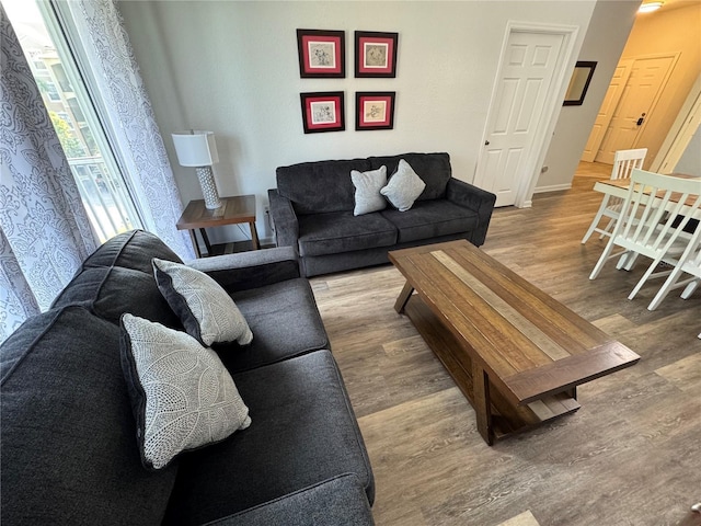 living room featuring wood finished floors and baseboards