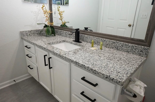 bathroom with vanity and baseboards