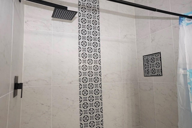 bathroom with tiled shower
