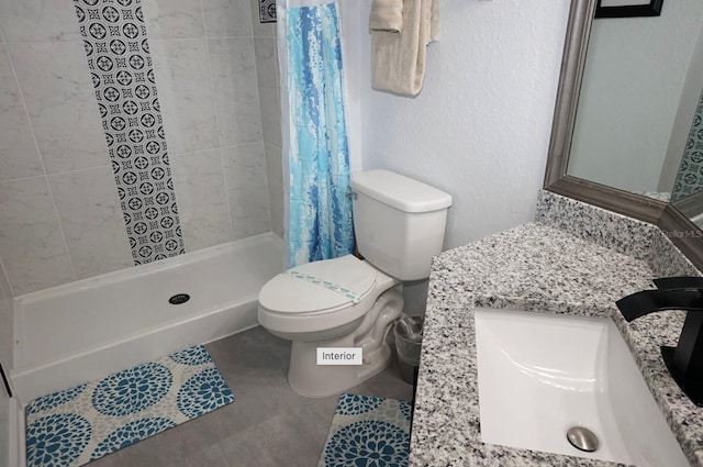 bathroom featuring a stall shower, toilet, vanity, and tile patterned floors