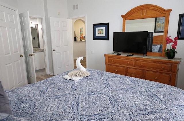 bedroom with arched walkways