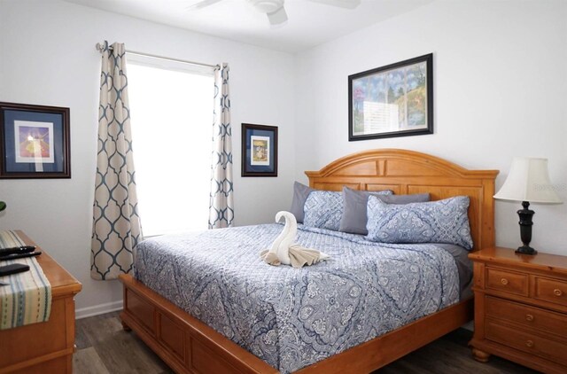 2778 Almaton Loop Unit 302, Kissimmee, FL 34747 - bedroom with dark wood-style floors, a ceiling fan, and baseboards