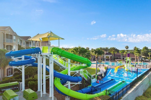 view of jungle gym featuring a community pool and a water play area