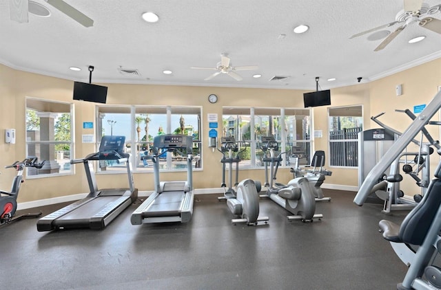 gym featuring ceiling fan, baseboards, crown molding, recessed lighting, and healthy amount of natural light