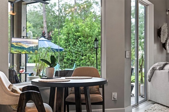 dining room featuring wood finished floors and baseboards