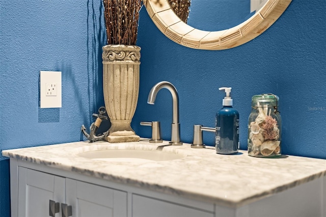 bathroom view of a textured wall and vanity