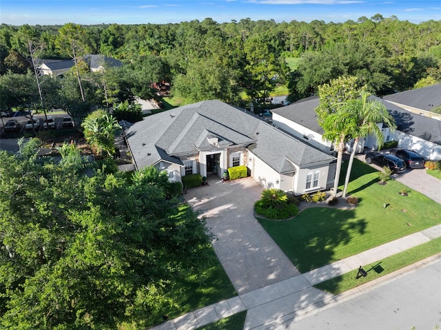 view from above of property featuring a heavily wooded area