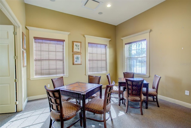 carpeted dining space with baseboards and recessed lighting