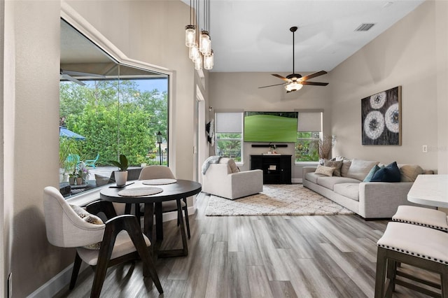 living room with wood finished floors and a ceiling fan