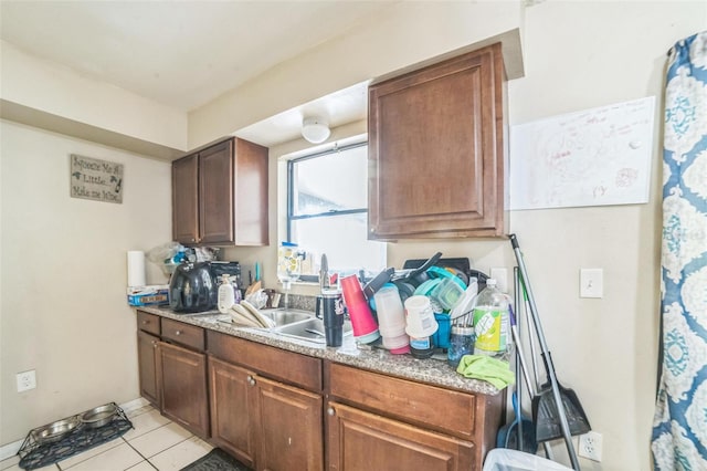 3711 Shady Grove Cir, Orlando, FL 32810 - kitchen featuring light tile patterned floors, a sink, and light countertops