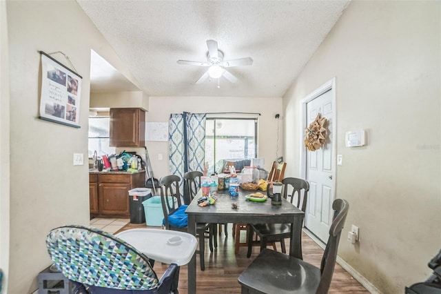 3711 Shady Grove Cir, Orlando, FL 32810 - dining space featuring a ceiling fan, a textured ceiling, and light wood-type flooring
