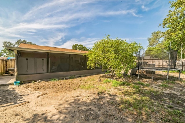 3711 Shady Grove Cir, Orlando, FL 32810 - view of yard with a trampoline, a sunroom, and fence