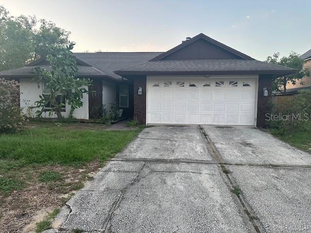 7625 Jarvis Ct, Orlando, FL 32818 - single story home featuring driveway and an attached garage