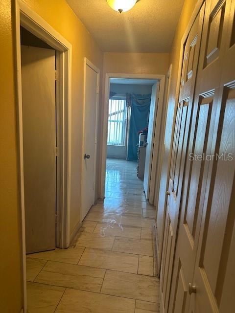 7625 Jarvis Ct, Orlando, FL 32818 - hall with a textured ceiling