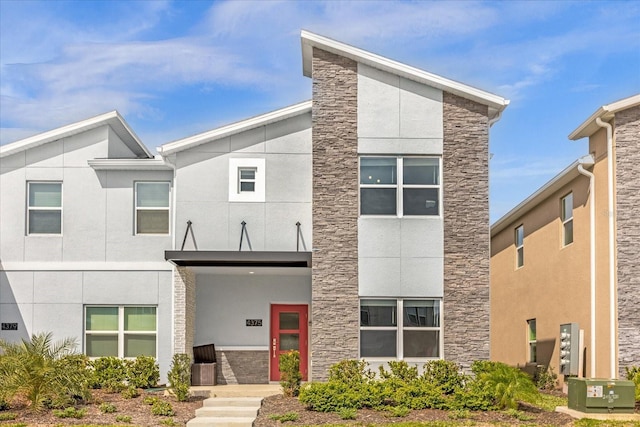 modern home with stone siding and stucco siding