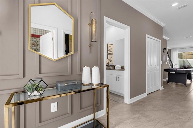 hall featuring ornamental molding and baseboards