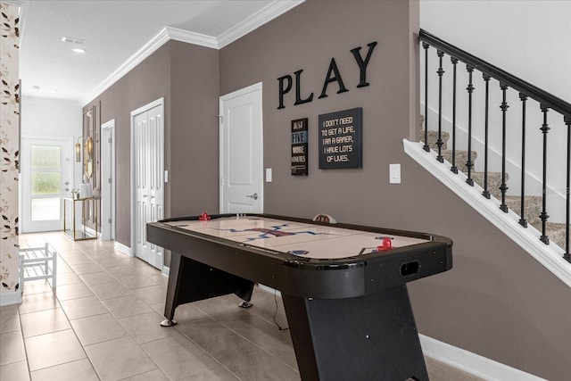 game room with baseboards, crown molding, and tile patterned flooring