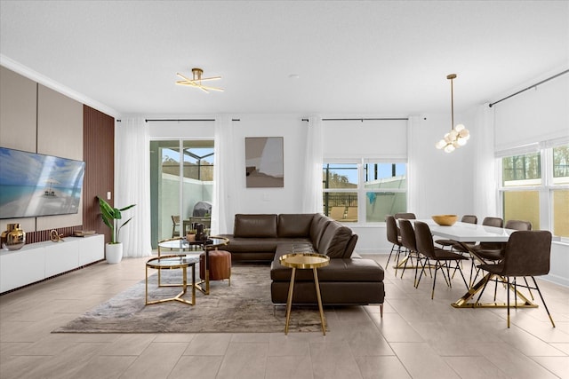 living room with a chandelier and crown molding