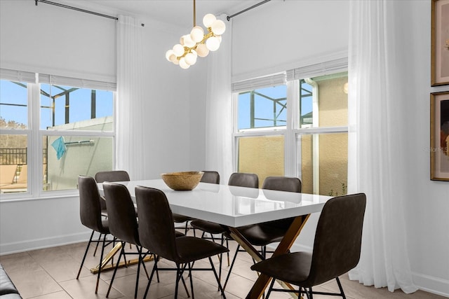 dining area featuring baseboards, light tile patterned floors, and a chandelier