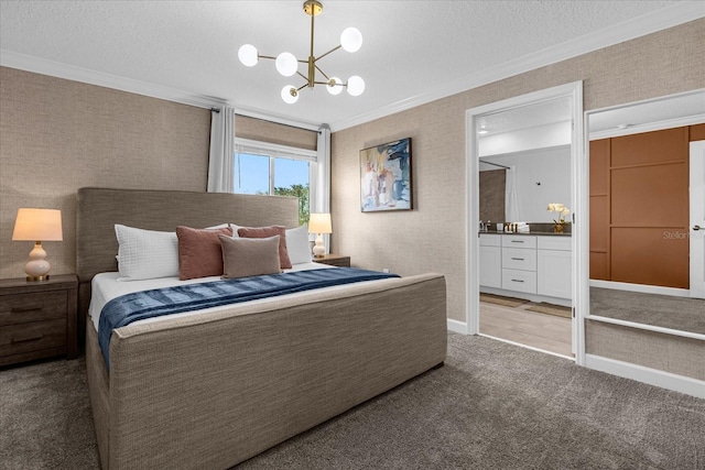 bedroom with ornamental molding, light colored carpet, a chandelier, a textured ceiling, and ensuite bath
