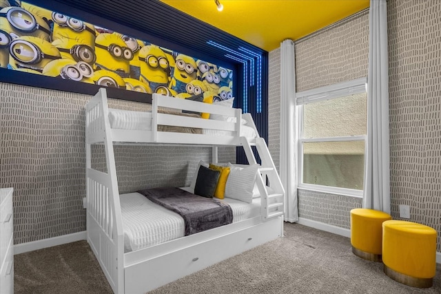 carpeted bedroom featuring baseboards