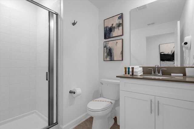 full bathroom with a stall shower, toilet, vanity, wood finished floors, and baseboards