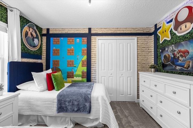 bedroom with dark colored carpet, a closet, and a textured ceiling