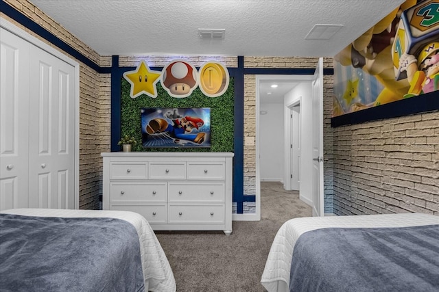 bedroom with carpet, a textured ceiling, and baseboards