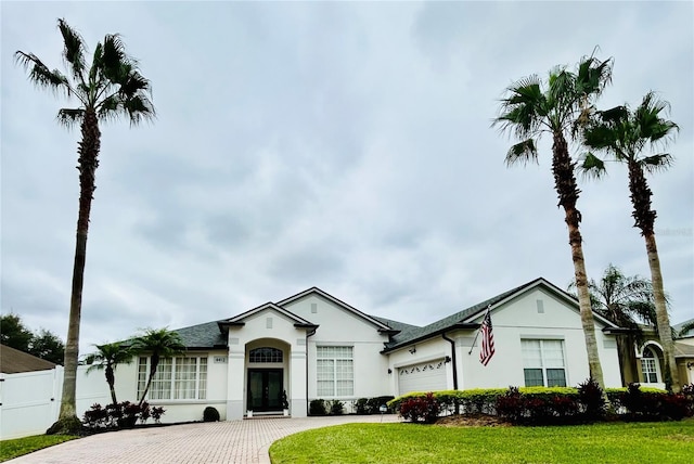 4412 Conroy Club Dr, Orlando, FL 32835 - ranch-style home with decorative driveway, a garage, and stucco siding