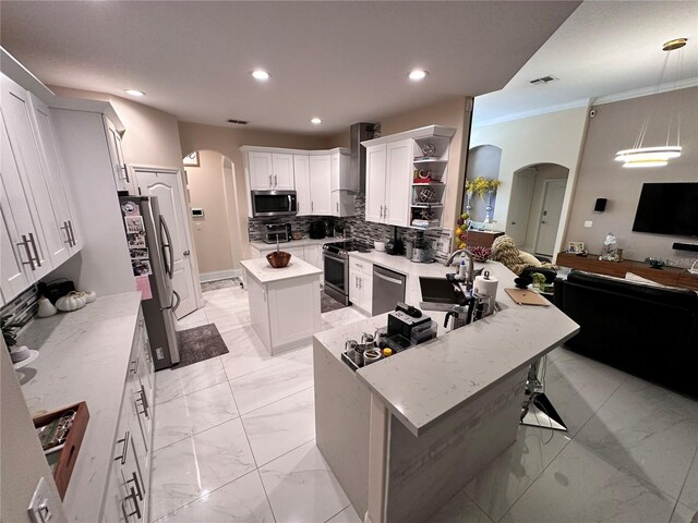 4412 Conroy Club Dr, Orlando, FL 32835 - kitchen featuring arched walkways, appliances with stainless steel finishes, open floor plan, open shelves, and recessed lighting