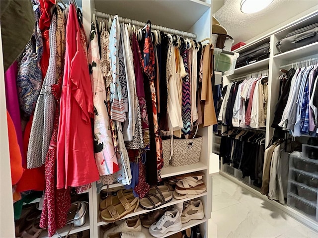 4412 Conroy Club Dr, Orlando, FL 32835 - walk in closet featuring marble look tile flooring