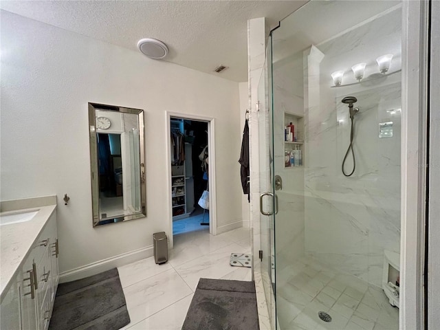 4412 Conroy Club Dr, Orlando, FL 32835 - full bath featuring a marble finish shower, a textured ceiling, vanity, marble finish floors, and a walk in closet
