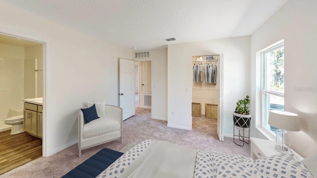 6690 E Lowden St, Inverness, FL 34452 - bedroom with light carpet, ensuite bathroom, and baseboards
