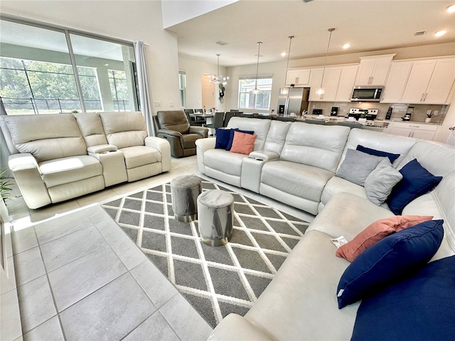 living room with recessed lighting, light tile patterned floors, and a chandelier