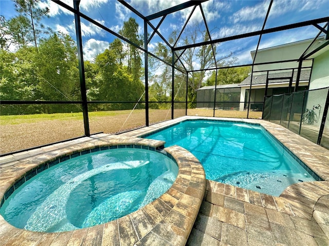 view of pool featuring a pool with connected hot tub, glass enclosure, and a patio