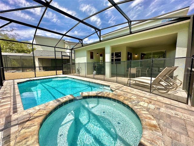 view of swimming pool with a pool with connected hot tub and a patio area