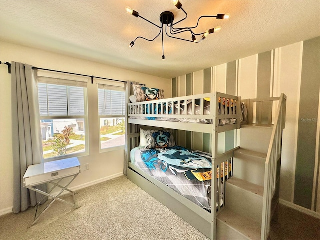 bedroom with a chandelier, carpet flooring, a textured ceiling, baseboards, and wallpapered walls