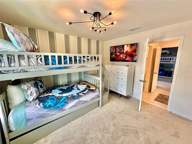 bedroom with wallpapered walls, carpet flooring, baseboards, a textured ceiling, and a chandelier