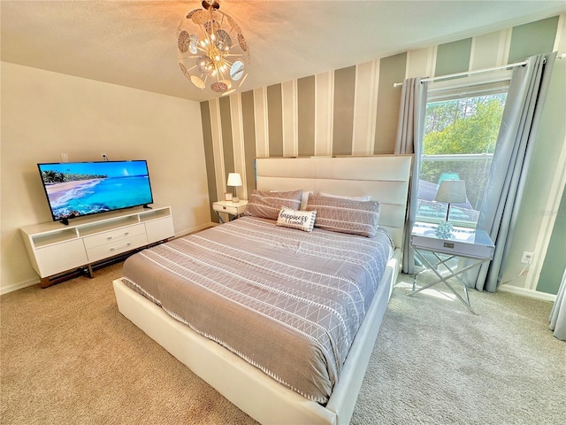 carpeted bedroom featuring baseboards, a chandelier, and wallpapered walls