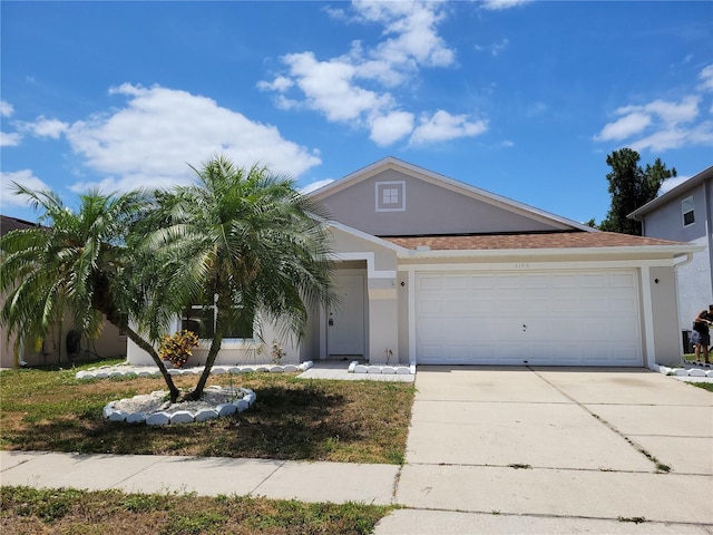 view of front facade featuring stucco siding, concrete driveway, and a garage