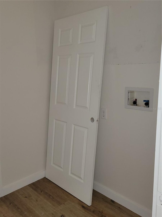 laundry area with washer hookup, wood finished floors, and baseboards