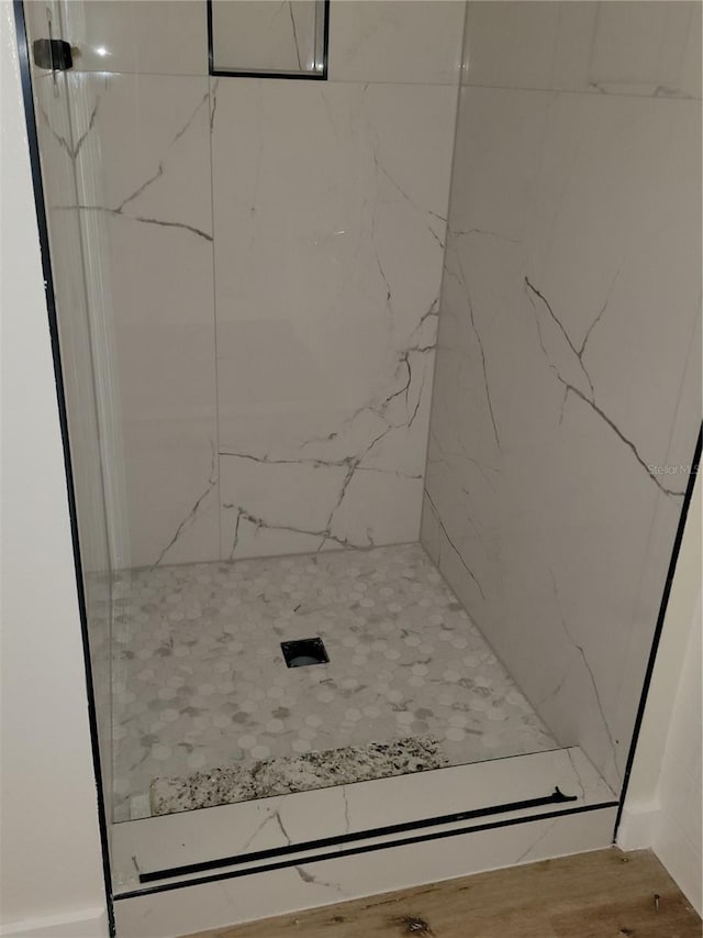 full bath featuring a marble finish shower