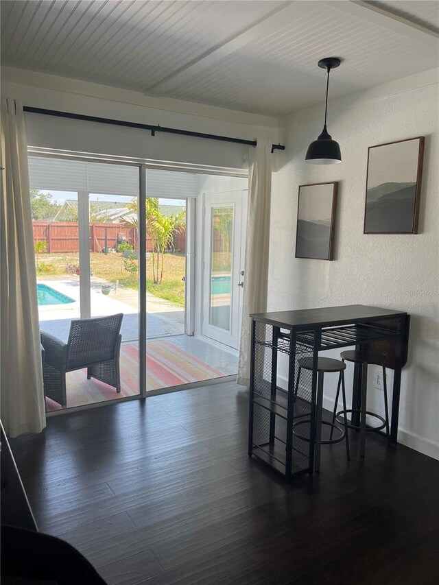 821 Silver Springs Ter NW, Port Charlotte, FL 33948 - dining room with dark wood-style floors and a textured wall