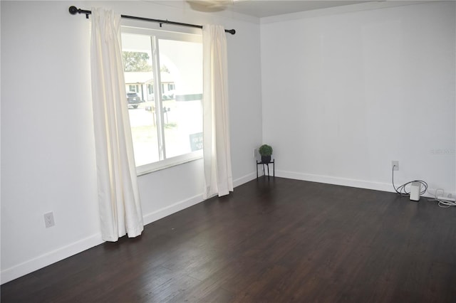 821 Silver Springs Ter NW, Port Charlotte, FL 33948 - empty room featuring dark wood-style floors, healthy amount of natural light, and baseboards