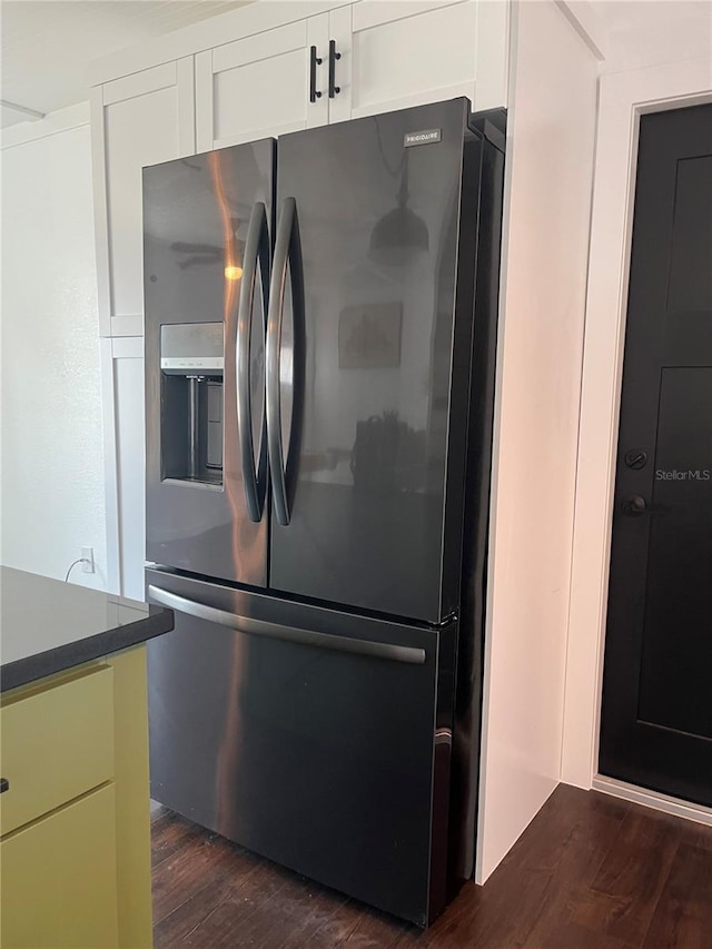 821 Silver Springs Ter NW, Port Charlotte, FL 33948 - kitchen featuring fridge with ice dispenser, dark wood-type flooring, white cabinets, and dark countertops