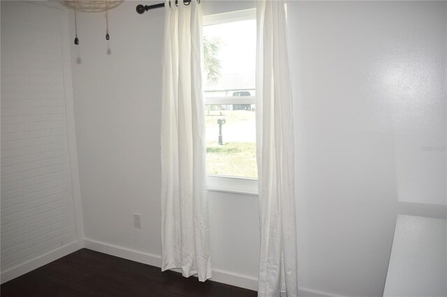 821 Silver Springs Ter NW, Port Charlotte, FL 33948 - unfurnished room with dark wood-style floors, plenty of natural light, and baseboards