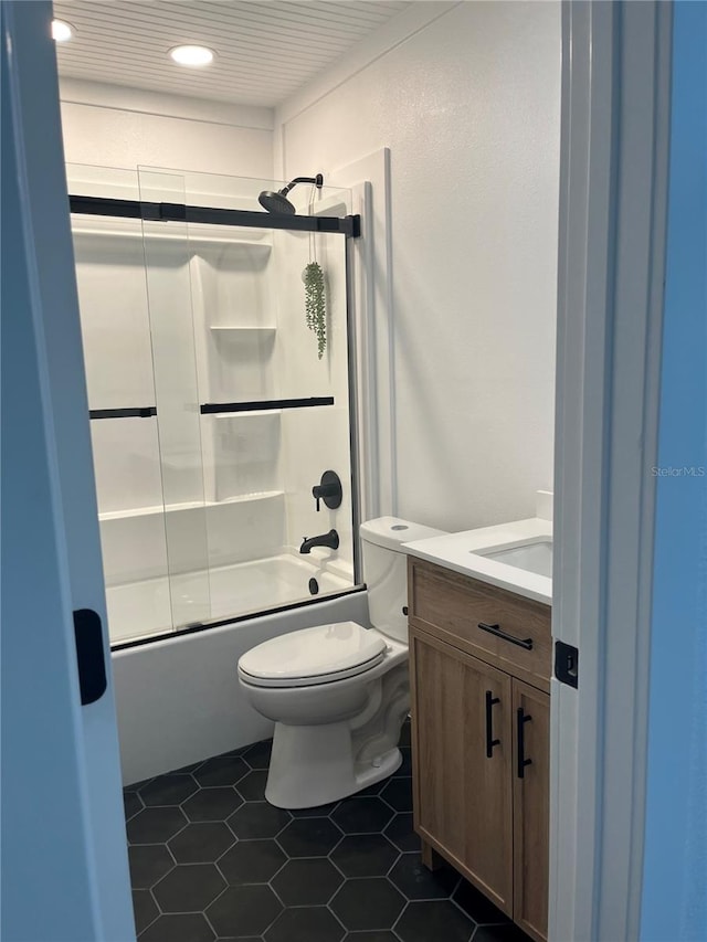 821 Silver Springs Ter NW, Port Charlotte, FL 33948 - bathroom featuring vanity, toilet, shower / bath combination with glass door, tile patterned flooring, and recessed lighting