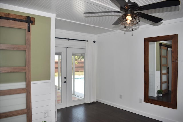 821 Silver Springs Ter NW, Port Charlotte, FL 33948 - unfurnished room with french doors, dark wood-style floors, a barn door, baseboards, and a ceiling fan